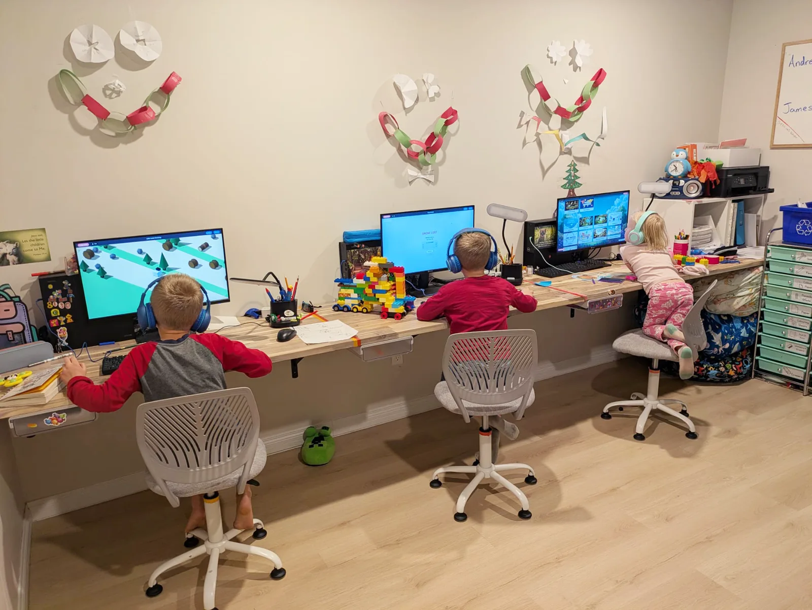Three kids using Genesis Desktop at their homeschool desks