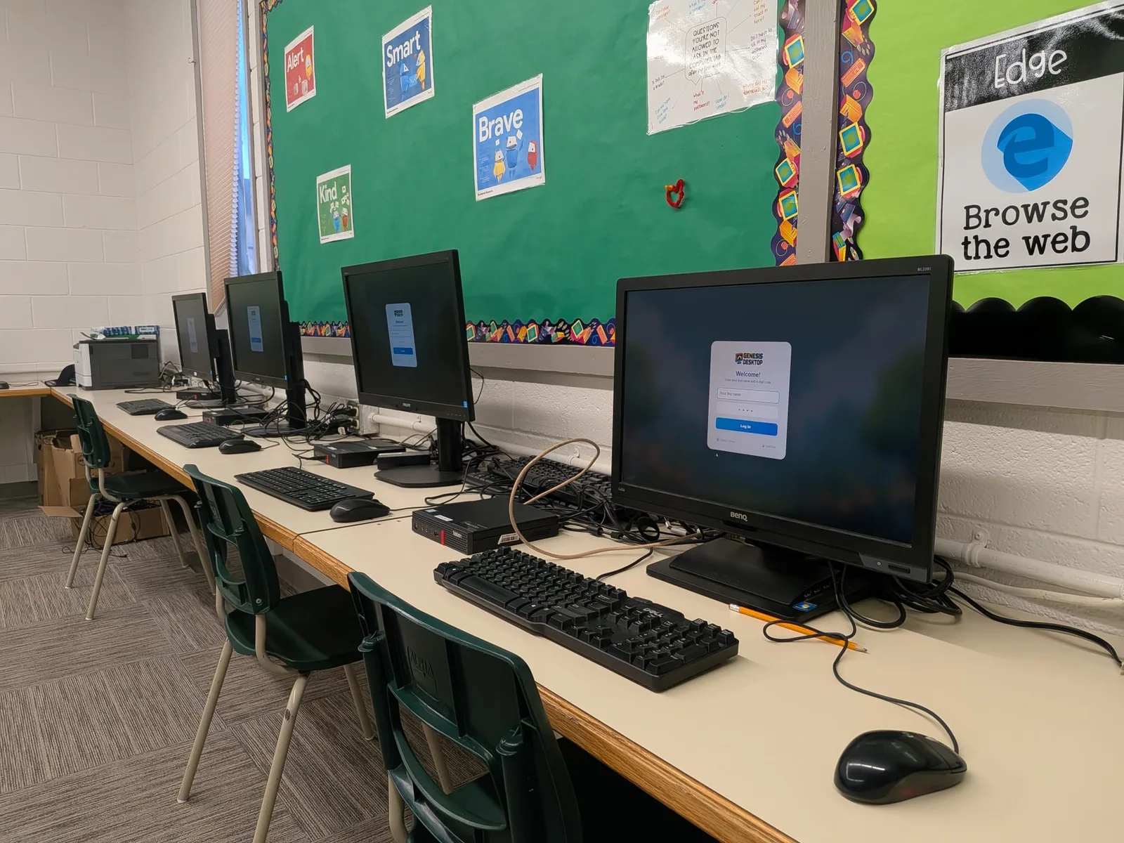 Row of school computers at the Genesis sign-in screen